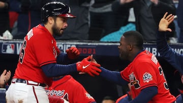 ATLANTA, GEORGIA - OCTOBER 29: Travis d'Arnaud #16 of the Atlanta Braves is congratulated by Guillermo Heredia #38 after hitting a one run home run against the Houston Astros during the eighth inning in Game Three of the World Series at Truist Park o